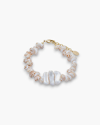 Raya Anklet with spotted shells and pearls on a white background