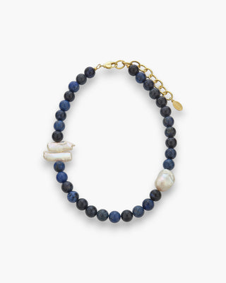 Willow Necklace with deep blue dumortierite beads, baroque pearls, and Biwa pearls on a white background
